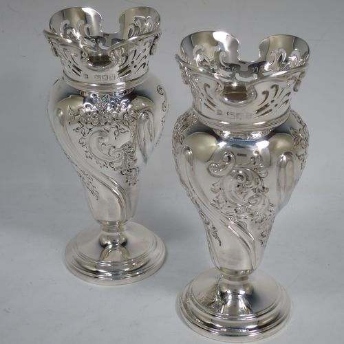 A very pretty pair of Antique Victorian Sterling Silver Art Nouveau style vases, having hand-chased floral and scroll decoration, with hand-pierced upper necks and applied scroll borders, and all  sitting on round stepped pedestal feet. Made by Walter and Charles Sissons of London in 1900. The dimensions of this fine pair of hand-made antique silver Art Nouveau vases are height 17 cms (6.75 inches), and diameter at top 7 cms (2.75 inches). Please note that these vases are not loaded, and the total weight of silver is 422g (13.6 troy ounces).    
