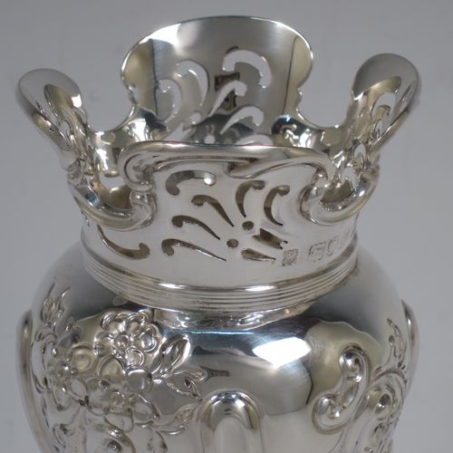 A very pretty pair of Antique Victorian Sterling Silver Art Nouveau style vases, having hand-chased floral and scroll decoration, with hand-pierced upper necks and applied scroll borders, and all sitting on round stepped pedestal feet. Made by Walter and Charles Sissons of London in 1900. The dimensions of this fine pair of hand-made antique silver Art Nouveau vases are height 17 cms (6.75 inches), and diameter at top 7 cms (2.75 inches). Please note that these vases are not loaded, and the total weight of silver is 422g (13.6 troy ounces).