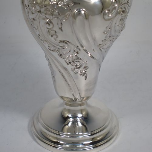 A very pretty pair of Antique Victorian Sterling Silver Art Nouveau style vases, having hand-chased floral and scroll decoration, with hand-pierced upper necks and applied scroll borders, and all sitting on round stepped pedestal feet. Made by Walter and Charles Sissons of London in 1900. The dimensions of this fine pair of hand-made antique silver Art Nouveau vases are height 17 cms (6.75 inches), and diameter at top 7 cms (2.75 inches). Please note that these vases are not loaded, and the total weight of silver is 422g (13.6 troy ounces).