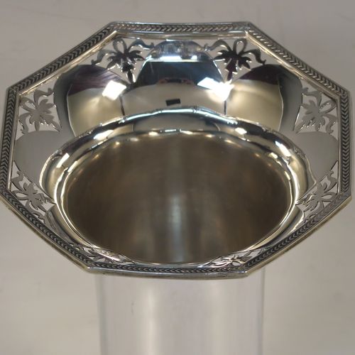 A very pretty pair of Sterling Silver table flower vases, having plain round bodies with tapering sides, with hand-pierced and applied rope-twist top borders, and sitting on plain hexagonal pedestal feet. These beautiful silver vases were made by Walker and Hall of Sheffield in 1924. The dimensions of this fine hand-made silver pair of vases are height 19 cms (7.5 inches), and width at top 10 cms (4 inches).
