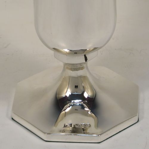 A very pretty pair of Sterling Silver table flower vases, having plain round bodies with tapering sides, with hand-pierced and applied rope-twist top borders, and sitting on plain hexagonal pedestal feet. These beautiful silver vases were made by Walker and Hall of Sheffield in 1924. The dimensions of this fine hand-made silver pair of vases are height 19 cms (7.5 inches), and width at top 10 cms (4 inches).