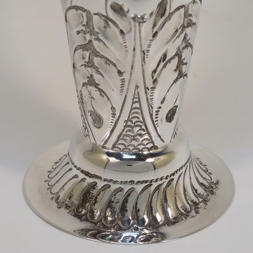 A very pretty Antique Victorian Sterling Silver pair of table flower vases, having round hand-chased bodies with tapering sides, with floral and fluted decoration, and all sitting on pedestal feet. These beautiful antique silver vases were made by Mappin and Webb of London in 1896. The dimensions of these fine hand-made antique silver pair of vases are height 16 cms (6.25 inches), diameter at top 6.5 cms (2.5 inches), and they weigh at total of approx. 200g (6.5 troy ounces). Please note that these vases are not loaded, so the whole weight is silver.