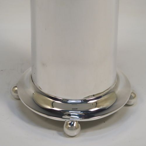 A very handsome pair of Antique Edwardian Sterling Silver table flower vases, having round straight-sided bodies with a top band of hand-chased neoclassical bow and swag style decoration, and sitting on four ball feet. These elegant silver vases were made by Roberts and Belk of Sheffield in 1907. The dimensions of these fine hand-made antique silver pair of vases are height 18.5 cms (7.25 inches), diameter at top 9 cms (3.5 inches), and they weigh at total of approx. 434g (14 troy ounces). Please note that these vases are not loaded.