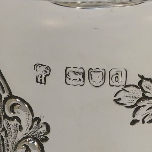 A very pretty Antique Victorian Sterling Silver table flower vase, having a round body with tapering sides and hand-chased floral and swirl-fluted decoration, and all sitting on pedestal feet. This beautiful antique silver vase was made by Charles Stuart Harris of London in 1899. The dimensions of these fine hand-made antique silver vase are height 15 cms (6 inches), diameter at top 7.5 cms (3 inches), and it weighs approx. 172g (5.5 troy ounces). Please note that this vase is not loaded, so the whole weight is silver.