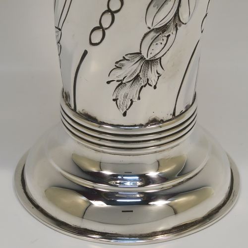 A very pretty Antique Victorian Sterling Silver table flower vase, having a round body with tapering sides and hand-chased floral and swirl-fluted decoration, and all sitting on pedestal feet. This beautiful antique silver vase was made by Charles Stuart Harris of London in 1899. The dimensions of these fine hand-made antique silver vase are height 15 cms (6 inches), diameter at top 7.5 cms (3 inches), and it weighs approx. 172g (5.5 troy ounces). Please note that this vase is not loaded, so the whole weight is silver.