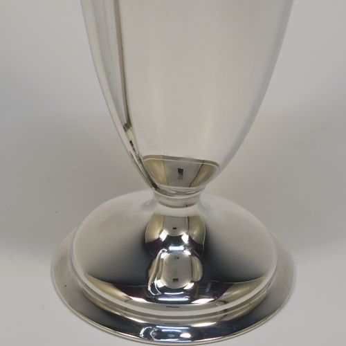 A very handsome pair of Antique Sterling Silver vases, having plain round bodies with tapering sides, with two flying scroll side handles, and applied double scroll top borders, and all sitting on round pedestal feet. These elegant silver vases were made by John Round of Sheffield in 1920. The dimensions of these fine hand-made antique silver vases are height 19 cms (7.5 inches), spread across arms 9 cms (3.5 inches), diameter of bodies at widest point 6 cms (23 inches), and they weigh approx. 354g (11.4 troy ounces). Please note that these vases are not loaded.
