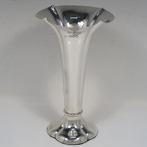 A very handsome Antique Edwardian Sterling Silver table flower vase, having a plain tapering round body with four hand-chased fluted panels, and sitting on a quattro foil pedestal foot. This elegant antique silver flower vase was made by Horace Woodward of London in 1910. The dimensions of this fine hand-made antique silver vase are height 18 cms (7 inches), and diameter at top 10 cms (4 inches).   