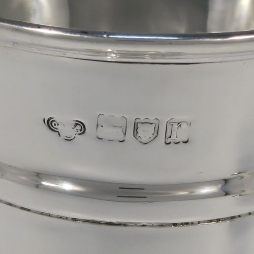 A very handsome pair of Antique Sterling Silver table flower vases, having very plain round tapering bodies, with upper and lower applied bands , and sitting on round pedestal feet. These elegant silver vases were made by Goldsmiths and Silversmiths of London in 1912. The dimensions of these fine hand-made pair of antique silver vases are height 18 cms (7 inches), diameter at top 6.5 cms (2.5 inches), and they weigh a total of 311g (10 troy ounces). Please note that these vases are not filled, so the whole weight is silver.