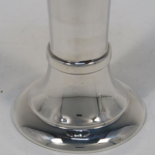 A very handsome pair of Antique Sterling Silver table flower vases, having very plain round tapering bodies, with upper and lower applied bands , and sitting on round pedestal feet. These elegant silver vases were made by Goldsmiths and Silversmiths of London in 1912. The dimensions of these fine hand-made pair of antique silver vases are height 18 cms (7 inches), diameter at top 6.5 cms (2.5 inches), and they weigh a total of 311g (10 troy ounces). Please note that these vases are not filled, so the whole weight is silver.