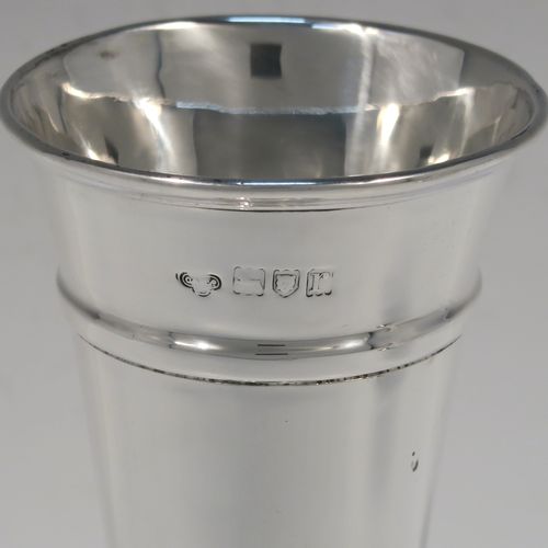 A very handsome pair of Antique Sterling Silver table flower vases, having very plain round tapering bodies, with upper and lower applied bands , and sitting on round pedestal feet. These elegant silver vases were made by Goldsmiths and Silversmiths of London in 1912. The dimensions of these fine hand-made pair of antique silver vases are height 18 cms (7 inches), diameter at top 6.5 cms (2.5 inches), and they weigh a total of 311g (10 troy ounces). Please note that these vases are not filled, so the whole weight is silver.