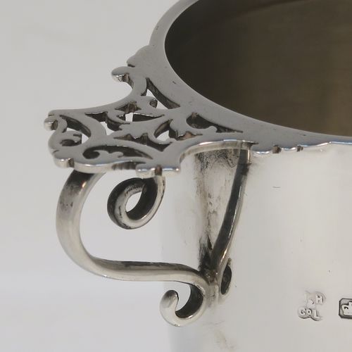 A very elegant pair of Antique Victorian Sterling Silver vases, having plain round bodies with tapering sides, with two scroll side handles and hand-pierced thumb-pieces, and all sitting on round pedestal feet. These handsome silver vases were made by Martin Hall and Co. Ltd., of Sheffield in 1896. The dimensions of these fine hand-made antique silver vases are height 12.5 cms (5 inches), spread across handles 10 cms (4 inches), diameter of bodies at lip 5.5 cms (2.25 inches), and they weigh approx. 277g (8.9 troy ounces). Please note that these vases are not loaded.