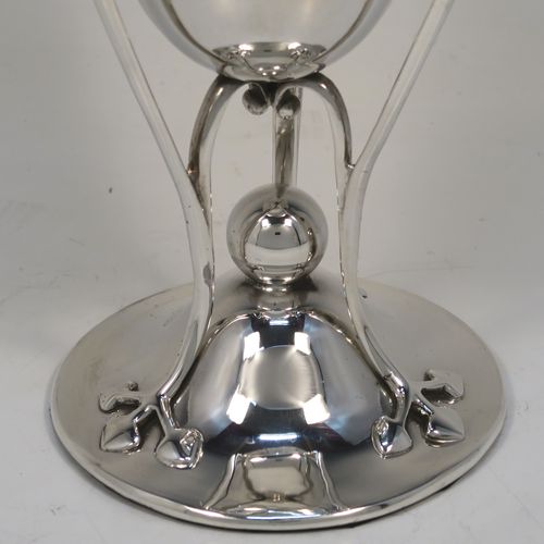 A very pretty and unusual pair of Antique Art Nouveau style Edwardian Sterling Silver vases, having plain round central bodies with tapering sides, attached to round spreading bases with three tendril and leaf style arms. These beautiful silver vases were made by Richard Richardson of Sheffield in 1904. The dimensions of this fine pair of hand-made antique silver Art Nouveau vases are height 19 cms (7.5 inches), and diameter at lips 8.5 cms (3.3 inches).