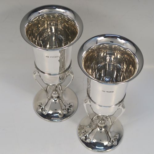 A very pretty and unusual pair of Antique Art Nouveau style Edwardian Sterling Silver vases, having plain round central bodies with tapering sides, attached to round spreading bases with three tendril and leaf style arms. These beautiful silver vases were made by Richard Richardson of Sheffield in 1904. The dimensions of this fine pair of hand-made antique silver Art Nouveau vases are height 19 cms (7.5 inches), and diameter at lips 8.5 cms (3.3 inches).