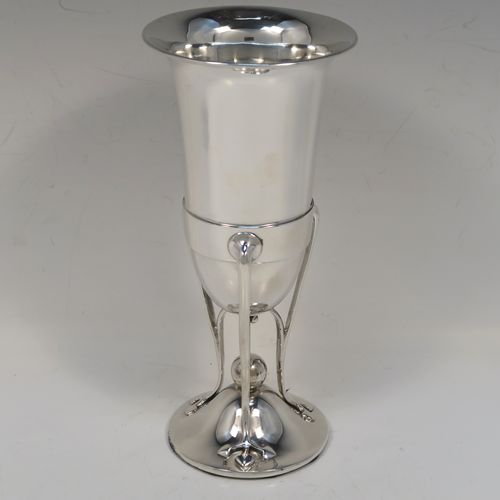 A very pretty and unusual pair of Antique Art Nouveau style Edwardian Sterling Silver vases, having plain round central bodies with tapering sides, attached to round spreading bases with three tendril and leaf style arms. These beautiful silver vases were made by Richard Richardson of Sheffield in 1904. The dimensions of this fine pair of hand-made antique silver Art Nouveau vases are height 19 cms (7.5 inches), and diameter at lips 8.5 cms (3.3 inches).