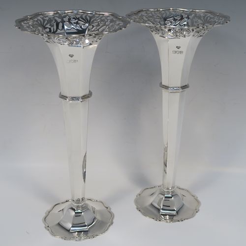 A very handsome and large pair of Antique Edwardian Sterling Silver table flower vases, having plain octagonal panelled bodies with tapering sides, with hand-pierced floral and scroll style decoration at the top, and sitting on pedestal feet with applied scroll borders. These elegant silver vases were made by Goldsmiths and Silversmiths of London in 1907. The dimensions of these fine hand-made antique silver pair of vases are height 26 cms (10.25 inches), diameter at top 12 cms (4.75 inches), and they weigh a total of 440g (14.2 troy ounces). Please note that these are not loaded, so the whole weight is silver. 