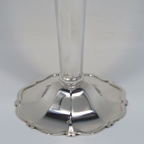 A very handsome and large pair of Antique Edwardian Sterling Silver table flower vases, having plain octagonal panelled bodies with tapering sides, with hand-pierced floral and scroll style decoration at the top, and sitting on pedestal feet with applied scroll borders. These elegant silver vases were made by Goldsmiths and Silversmiths of London in 1907. The dimensions of these fine hand-made antique silver pair of vases are height 26 cms (10.25 inches), diameter at top 12 cms (4.75 inches), and they weigh a total of 440g (14.2 troy ounces). Please note that these are not loaded, so the whole weight is silver.
