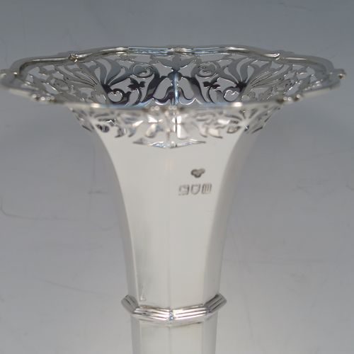 A very handsome and large pair of Antique Edwardian Sterling Silver table flower vases, having plain octagonal panelled bodies with tapering sides, with hand-pierced floral and scroll style decoration at the top, and sitting on pedestal feet with applied scroll borders. These elegant silver vases were made by Goldsmiths and Silversmiths of London in 1907. The dimensions of these fine hand-made antique silver pair of vases are height 26 cms (10.25 inches), diameter at top 12 cms (4.75 inches), and they weigh a total of 440g (14.2 troy ounces). Please note that these are not loaded, so the whole weight is silver.