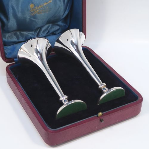 A handsome Antique Edwardian Sterling Silver pair of table flower vases, having very plain round tapering bodies, with petal-shaped mouths, and sitting on round pedestal feet, all in their original blue satin and velvet-line presentation box. These elegant silver vases were made by James Dixon and Sons of Sheffield in 1907. The dimensions of these fine hand-made pair of antique silver vases are height 14,5 cms (5.75 inches), and diameter at top 6 cms (2.3 inches).   