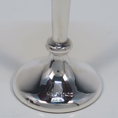 A handsome Antique Edwardian Sterling Silver pair of table flower vases, having very plain round tapering bodies, with petal-shaped mouths, and sitting on round pedestal feet, all in their original blue satin and velvet-line presentation box. These elegant silver vases were made by James Dixon and Sons of Sheffield in 1907. The dimensions of these fine hand-made pair of antique silver vases are height 14,5 cms (5.75 inches), and diameter at top 6 cms (2.3 inches).