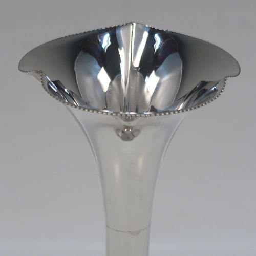 A handsome Antique Edwardian Sterling Silver pair of table flower vases, having very plain round tapering bodies, with petal-shaped mouths, and sitting on round pedestal feet, all in their original blue satin and velvet-line presentation box. These elegant silver vases were made by James Dixon and Sons of Sheffield in 1907. The dimensions of these fine hand-made pair of antique silver vases are height 14,5 cms (5.75 inches), and diameter at top 6 cms (2.3 inches).