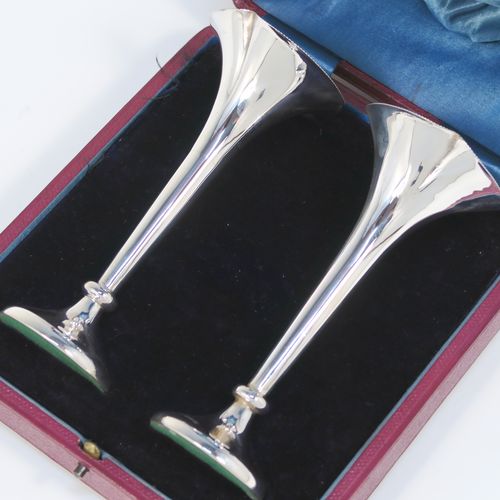 A handsome Antique Edwardian Sterling Silver pair of table flower vases, having very plain round tapering bodies, with petal-shaped mouths, and sitting on round pedestal feet, all in their original blue satin and velvet-line presentation box. These elegant silver vases were made by James Dixon and Sons of Sheffield in 1907. The dimensions of these fine hand-made pair of antique silver vases are height 14,5 cms (5.75 inches), and diameter at top 6 cms (2.3 inches).