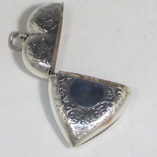 Antique Victorian sterling silver vesta case, having a heart-shaped body, with hand-engraved floral decoration, a hinged lid with security ring for attaching to a chain, a gold-gilt interior, and a vacant cartouche on one side. Made in London in 1896. The dimensions of this fine hand-made antique silver vesta case are length 6 cms (2.25 inches), width 4.5 cms (1.75 inches), and it weighs approx. 30g (1 troy ounce).
