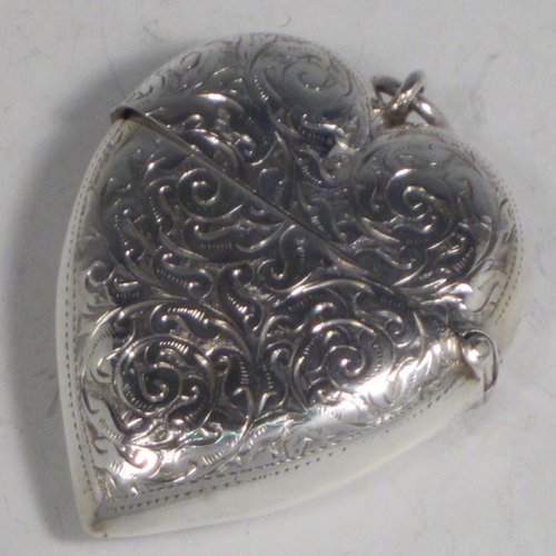 Antique Victorian sterling silver vesta case, having a heart-shaped body, with hand-engraved floral decoration, a hinged lid with security ring for attaching to a chain, a gold-gilt interior, and a vacant cartouche on one side. Made in London in 1896. The dimensions of this fine hand-made antique silver vesta case are length 6 cms (2.25 inches), width 4.5 cms (1.75 inches), and it weighs approx. 30g (1 troy ounce).