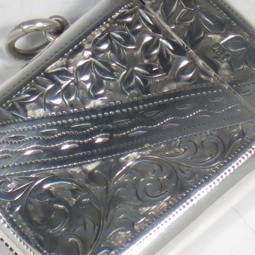 An Antique Edwardian Sterling silver Vesta case, having a rectangular body, with hand-engraved floral decoration, a hinged lid with security ring for attaching to a chain, a gold-gilt interior, and a vacant cartouche on one side. Made in Birmingham in 1905. The dimensions of this fine hand-made antique silver Vesta case are length 5.5 cms (2.2 inches), width 4 cms (1.5 inches), and it weighs approx. 29g (1 troy ounce).
