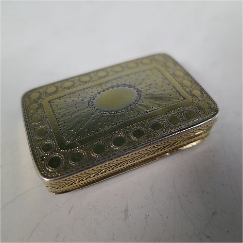 An Antique Georgian Sterling Silver and gold-gilt vinaigrette, having a rectangular body with hand-engraved floral decoration, a hinged lid, a gold-gilt interior with hinged geometrically pierced and engraved grill. Made by Joseph Wilmore, of Birmingham in 1812. The dimensions of this fine hand-made antique silver vinaigrette are length 3.2 cms (1.25 inches), width 2 cms (0.75 inches), and depth 0.8 cms (0.3 inches).    