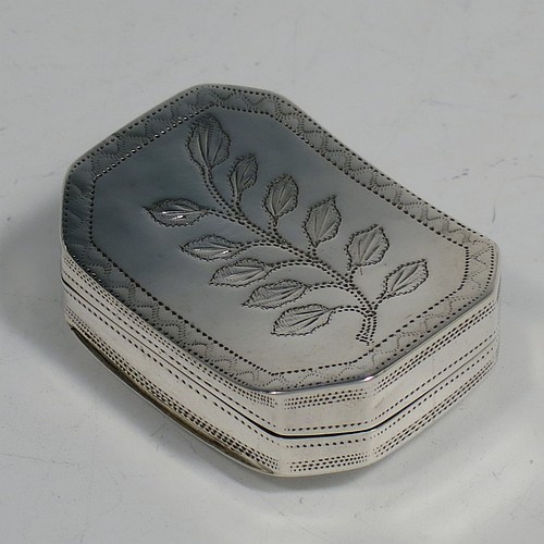 An Antique Georgian Sterling Silver vinaigrette, having a rectangular cut-cornered concave body with hand-engraved three-leaf clovers decoration on the top and floral decoration on the base, a gold-gilt interior, and a sun-motif hand-pierced grill. Made by Samuel Pemberton of Birmingham in 1809. The dimensions of this fine hand-made antique silver vinaigrette are length 4 cms (1.5 inch), width 3 cm (1.25 inch), and depth 1.2 cm (0.5 inches).
