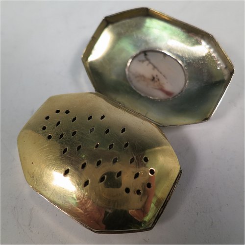 An Antique Georgian Sterling Silver vinaigrette, having an octagonal body with a mounted oval moss agate, surrounded by hand-engraved bands and floral decoration, a plain base, a gold-gilt interior, and a plain hand-pierced grill. Made by Joseph Wilmore Birmingham in 1812. The dimensions of this fine hand-made antique silver vinaigrette are length 4 cms (1.5 inches), width 3 cms (1.25 inches), and depth 2 cms (0.75 inches).