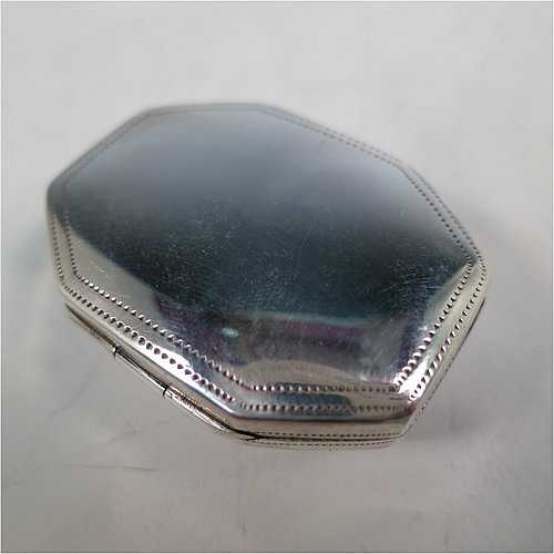An Antique Georgian Sterling Silver vinaigrette, having an octagonal body with a mounted oval moss agate, surrounded by hand-engraved bands and floral decoration, a plain base, a gold-gilt interior, and a plain hand-pierced grill. Made by Joseph Wilmore Birmingham in 1812. The dimensions of this fine hand-made antique silver vinaigrette are length 4 cms (1.5 inches), width 3 cms (1.25 inches), and depth 2 cms (0.75 inches).