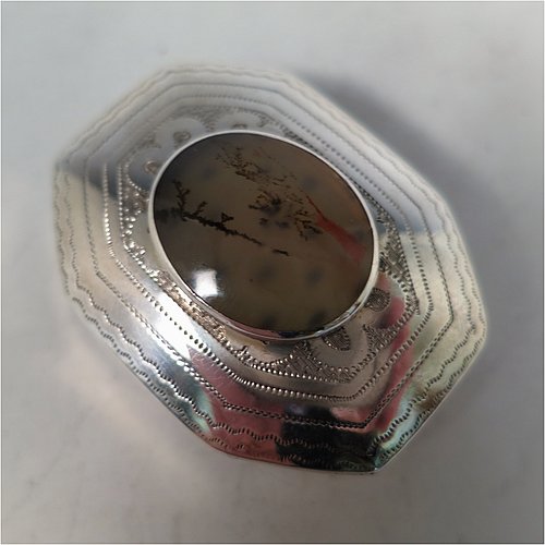 An Antique Georgian Sterling Silver vinaigrette, having an octagonal body with a mounted oval moss agate, surrounded by hand-engraved bands and floral decoration, a plain base, a gold-gilt interior, and a plain hand-pierced grill. Made by Joseph Wilmore Birmingham in 1812. The dimensions of this fine hand-made antique silver vinaigrette are length 4 cms (1.5 inches), width 3 cms (1.25 inches), and depth 2 cms (0.75 inches).