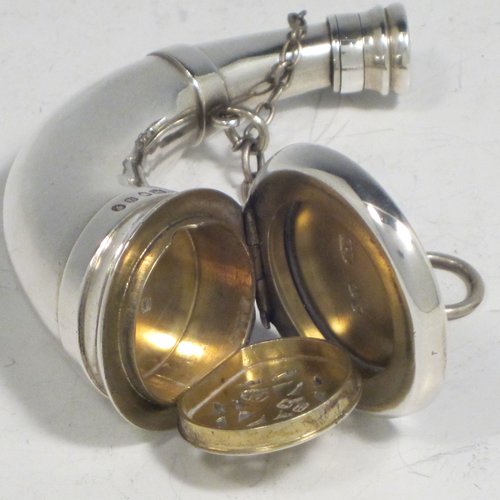 Antique Victorian sterling silver combination vinaigrette and scent bottle, in the shape of a horn, having a plain round body, with attached security chains, a main hinged cover with a gold-gilt interior, a hinged hand-pierced and engraved internal grill, and a another screw-top cover for adding perfume. Made by Thomas Johnson of London in 1875. The dimensions of this fine hand-made silver combination vinaigrette and scent bottle are length 9 cms (3.5 inches), width 3.5 cms (1.3 inches), and it weighs approx. 55g (1.8 troy ounces).