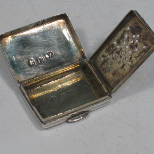 Antique Georgian sterling silver purse-form vinaigrette, having a rectangular body with hand-engraved decoration, a hinged lid, a gold-gilt interior with hinged hand-pierced and chased grill with floral decoration. Made by John Bettridge of Birmingham in 1833. The dimensions of this fine hand-made silver vinaigrette are length 3 cms (1.25 inches), and width 2 cms (0.75 inches).