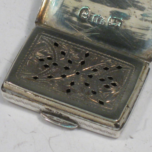 Antique Georgian sterling silver purse-form vinaigrette, having a rectangular body with hand-engraved decoration, a hinged lid, a gold-gilt interior with hinged hand-pierced and chased grill with floral decoration. Made by John Bettridge of Birmingham in 1833. The dimensions of this fine hand-made silver vinaigrette are length 3 cms (1.25 inches), and width 2 cms (0.75 inches).