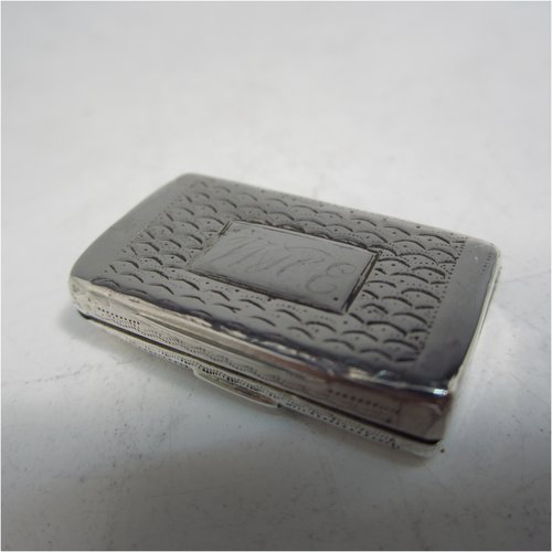 An Antique Georgian Sterling silver vinaigrette, in a Purse or Satchel form, having hand-engraved decoration, a gold-gilt interior, and a hand-pierced grill with thistle work. Made by Simpson & Son of Birmingham in 1816. The dimensions of this fine hand-made silver vinaigrette are length 2.8 cms (1.1 inches), width 1.7 cms (0.7 inches), and depth 0.8 cms (0.3 inches).