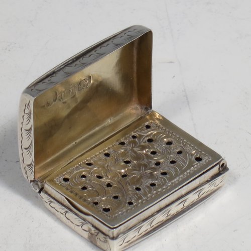 An Antique Victorian Sterling silver vinaigrette, having hand-engraved floral decoration, reeded sides, a gold-gilt interior, and a hand-pierced grill with floral work. Made by Joseph Taylor of Birmingham in 1843. The dimensions of this fine hand-made silver vinaigrette are length 2.5 cms (1 inch), width 2 cm (0.6 inches), and depth 0.8 cm (0.3 inches).