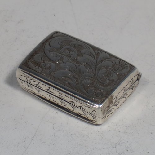 An Antique Victorian Sterling silver vinaigrette, having hand-engraved floral decoration, reeded sides, a gold-gilt interior, and a hand-pierced grill with floral work. Made by Joseph Taylor of Birmingham in 1843. The dimensions of this fine hand-made silver vinaigrette are length 2.5 cms (1 inch), width 2 cm (0.6 inches), and depth 0.8 cm (0.3 inches).