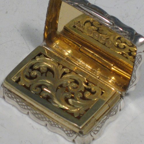 Antique Victorian sterling silver vinaigrette, having a rectangular shaped body with hand-engraved floral decoration (with roses and ferns), a hinged lid with vacant cartouche, and a gold-gilt interior with hinged hand-pierced and chased grill. Made by George Unite of Birmingham in 1838. The dimensions of this fine hand-made silver vinaigrette are length 3.5 cms (1.3 inches), and width 2.5 cms (1 inch).