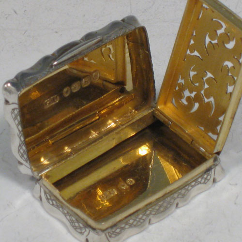 Antique Victorian sterling silver vinaigrette, having a rectangular shaped body with hand-engraved floral decoration (with roses and ferns), a hinged lid with vacant cartouche, and a gold-gilt interior with hinged hand-pierced and chased grill. Made by George Unite of Birmingham in 1838. The dimensions of this fine hand-made silver vinaigrette are length 3.5 cms (1.3 inches), and width 2.5 cms (1 inch).