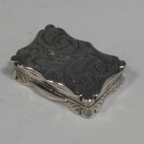 Antique Victorian sterling silver vinaigrette, having a rectangular shaped body with hand-engraved floral decoration and a vacant cartouche, a hinged lid, and a gold-gilt interior with hinged hand-pierced and chased grill. Made by Edward Smith of Birmingham in 1843. The dimensions of this fine hand-made silver vinaigrette are length 3.5 cms (1.3 inches), and width 2.5 cms (1 inch).