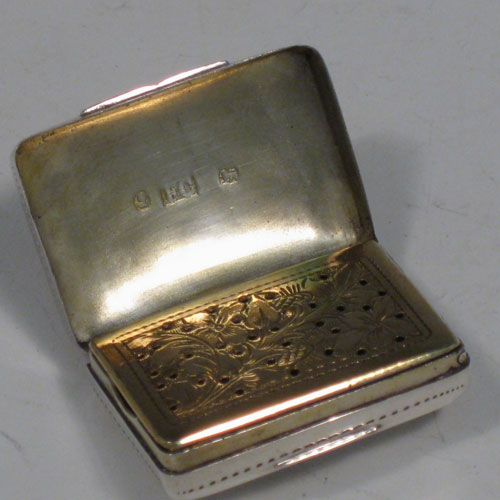 Antique Georgian sterling silver vinaigrette, having a rectangular body with hand-engraved floral decoration and a vacant cartouche, a hinged lid, a gold-gilt interior with hinged hand-chased grill. Made by Francis Clark, of Birmingham in 1834. The dimensions of this fine hand-made silver vinaigrette are length 3 cms (1.25 inches), and width 2 cms (0.75 inches).