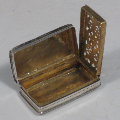 Antique Georgian sterling silver vinaigrette, having a rectangular body with hand-engraved floral decoration, a hinged lid, a gold-gilt interior with hinged sun-burst grill. Made by Lawrence & Co., of Birmingham in 1831. The dimensions of this fine hand-made silver vinaigrette are length 3.2 cms (1.25 inches), and width 1.7 cms (0.5 inches).