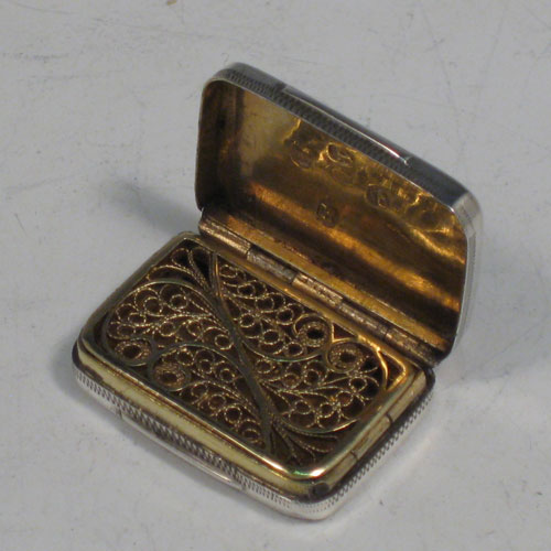 Antique Georgian sterling silver vinaigrette, having a rectangular body with hand-engraved Greek-Key decoration, a hinged lid, and a gold-gilt interior with hinged fillagree grill. Made by Samuel Pemberton of Birmingham in 1805. The dimensions of this fine hand-made silver vinaigrette are length 2.5 cms (1 inches), and width 2 cms (0.75 inches).