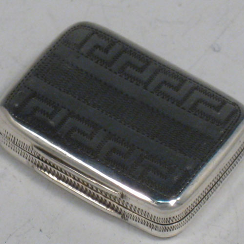 Antique Georgian sterling silver vinaigrette, having a rectangular body with hand-engraved Greek-Key decoration, a hinged lid, and a gold-gilt interior with hinged fillagree grill. Made by Samuel Pemberton of Birmingham in 1805. The dimensions of this fine hand-made silver vinaigrette are length 2.5 cms (1 inches), and width 2 cms (0.75 inches).