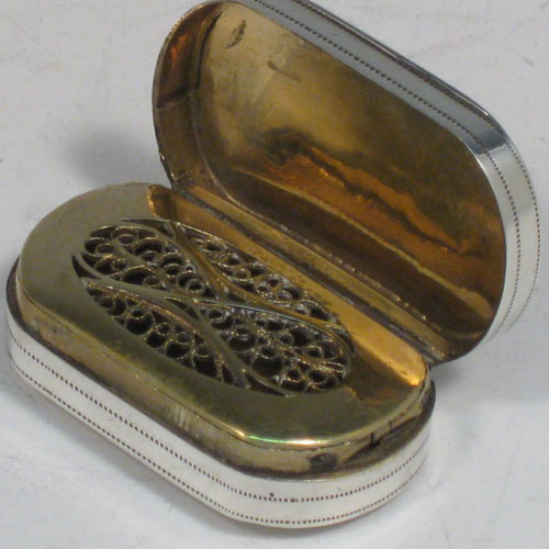 Antique Georgian sterling silver vinaigrette, having a rectangular body with rounded ends, a hand-engraved floral band of decoration, a hinged lid, and a gold-gilt interior with hinged fillagree grill. Made by Samuel Pemberton of Birmingham in 1800. The dimensions of this fine hand-made silver vinaigrette are length 3.5 cms (1.3 inches), and width 2 cms (0.75 inches).