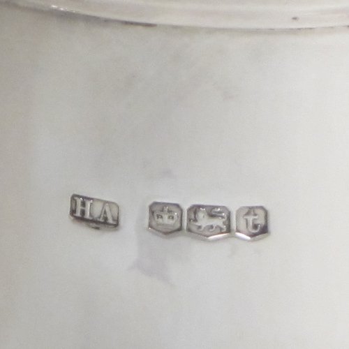 Sterling silver water jug, in a George I beer jug style, having a plain round bellied body, sparrow-beak spout, scroll handle, and sitting on a pedestal foot. Made by Henry Atkins of Sheffield in 1936. The dimensions of this fine hand-made silver water jug are height 21 cms (8.25 inches), length 16.5 cms (6.5 inches), length 14 cms (5.5 inches), and it weighs approx. 449g (14.5 troy ounces). Please note that this silver water jugs size would be perfect for serving two people.