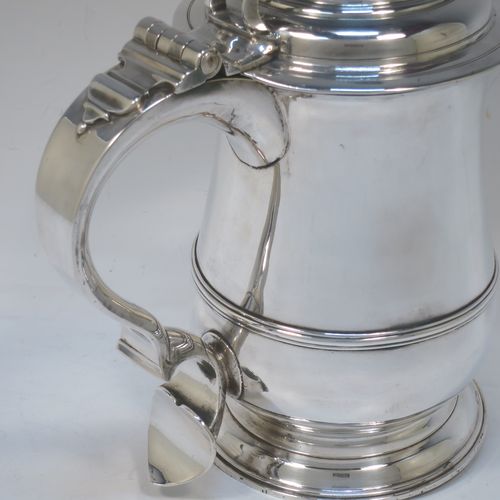 A very handsome Antique Georgian Sterling Silver water or beer jug, having a plain round bellied body with an applied central reeded girdle, a plain pouring spout, a scroll handle with heart-shaped terminal, a hinged domed lid with pierced thumb-piece, and sitting on a plain round stepped pedestal foot. Made by John Payne of London in 1754. The dimensions of this fine hand-made antique silver beer or water jug are height 21 cms (8.5 inches), length 21 cms (8.5 inches), and it weighs approx. 870g (28 troy ounces).