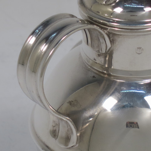 A small but handsome and unusual Antique Victorian Sterling Silver Guernsey style water / milk jug for one person, having a plain round bellied body with applied reeded girdles, a scroll handle, a pull-off lid, and all sitting on a flat base. Made by the Barnard Brothers of London in 1895. The dimensions of this fine hand-made antique silver Guernsey jug are height 9.5 cms (3.75 inches), diameter of body 7 cms (2.75 inches), and it weighs approx. 90g (3 troy ounces).